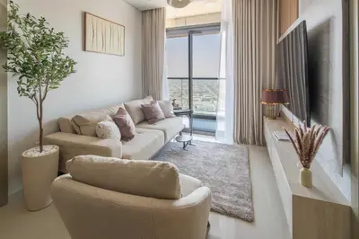 a living room with a couch and chairs and a tv at Frank Porter - Aykon City 2 Tower C in Dubai
