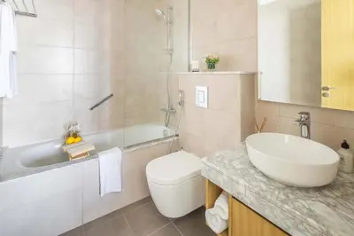 a bathroom with a sink and a toilet and a tub at Frank Porter - Aykon City 2 Tower C in Dubai