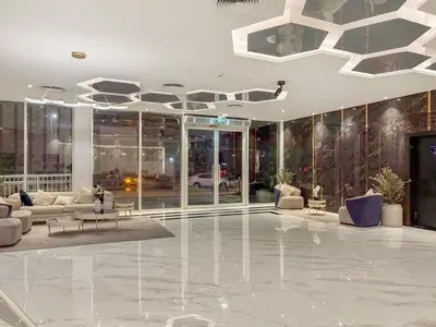 a lobby with couches and tables in a building at FIRST CLASS Studio Chic and Comfy in Jewelz in Dubai