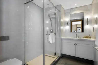 a bathroom with a shower and a toilet and a sink at Maison Privee - City Heights Retreat with Panoramic Skyline Views in Dubai