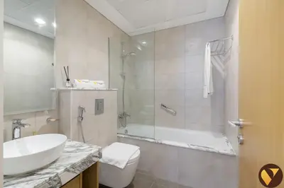 a bathroom with a sink and a toilet and a shower at Vogue Business Bay Aykon City Tower Close to Downtown Burj Khalifa and Dubai Mall, Two Bedroom Apartment with Large Balcony Sea view, Access to all Amenities in Dubai