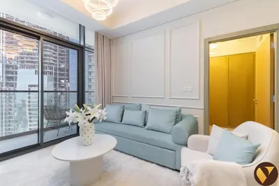a living room with a blue couch and a table at Vogue Business Bay Aykon City Tower Close to Downtown Burj Khalifa and Dubai Mall, Two Bedroom Apartment with Large Balcony Sea view, Access to all Amenities in Dubai
