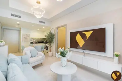 a living room with a couch and a tv on a wall at Vogue Business Bay Aykon City Tower Close to Downtown Burj Khalifa and Dubai Mall, Two Bedroom Apartment with Large Balcony Sea view, Access to all Amenities in Dubai