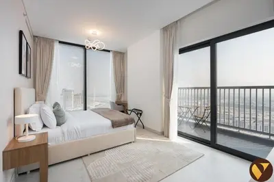 a bedroom with a bed and a large window at Vogue Al Maktoum City Sobha Hartland The Crest Near to Downtown, Burj Khalifa and Dubai Mall, Three Bedroom plus Kid's room apartment with Balcony and City View, Access to all Amenities in Dubai