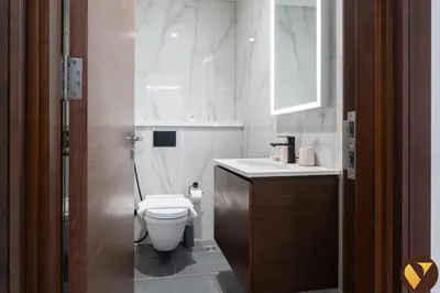 a bathroom with a toilet and a sink at Vogue Al Maktoum City Sobha Hartland The Crest Near to Downtown, Burj Khalifa and Dubai Mall, Three Bedroom plus Kid's room apartment with Balcony and City View, Access to all Amenities in Dubai