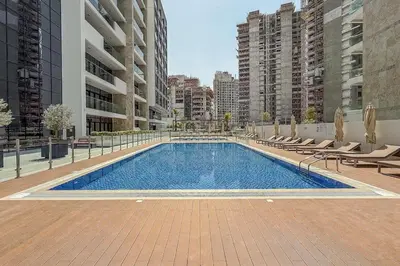 a swimming pool in the middle of a building at Airstay - Modern 1BR - Pool Views - Azizi 61 - Monthly Offer Available in Dubai