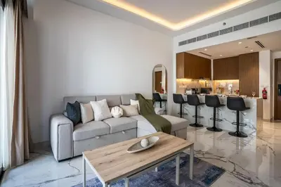 a living room with a couch and a table at Airstay - Modern 1BR - Pool Views - Azizi 61 - Monthly Offer Available in Dubai