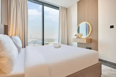 a bedroom with a large white bed and a large window at STAY BY LATINEM Luxury 2BR Holiday Home CB 1313 Near Burj Khalifa in Dubai