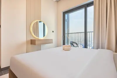 a bedroom with a large bed and a large window at STAY BY LATINEM Luxury 2BR Holiday Home CB 1313 Near Burj Khalifa in Dubai