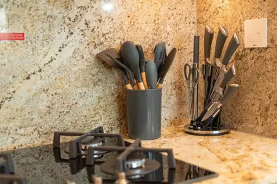 a container of utensils sitting on top of a counter at PVH - 1BR with Burj Khalifa View - Imperial Avenue in Dubai