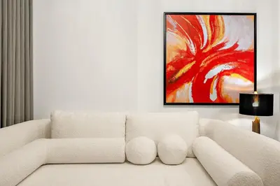a white couch in a living room with a painting at FIRST CLASS 1BR Modern Serenity , Near Downtown in Dubai