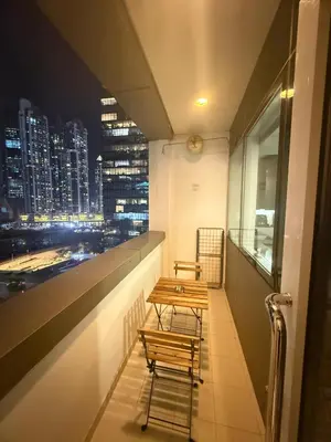 a balcony with two benches and a view of a city at Wecation- Chic 2BR Damac Maison Cour Jardin Business Bay in Dubai
