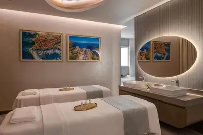 a bathroom with two beds and a sink and a mirror at Luxury 2B Burj Khalifa NYE Views, 5-Star Amenities in Dubai