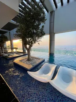 a pool with a tree in the middle of a building at Luxury 2B Burj Khalifa NYE Views, 5-Star Amenities in Dubai