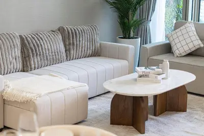 a living room with a couch and a table at Full Burj Khalifa And Fountains View Exclusive 2BR Luxury Apartment In The Heart Of Downtown Dubai in Dubai