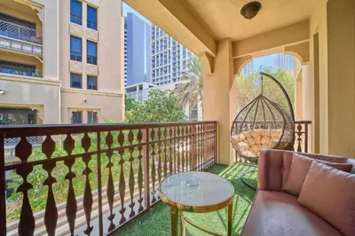 a balcony with a couch and a swing at FAM Living - 2 Bedroom Old Town Dubai Stay in Dubai