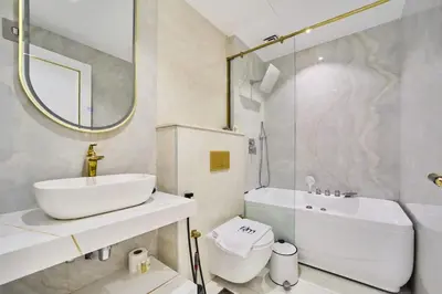a bathroom with a sink and a toilet and a mirror at FAM Living - 2 Bedroom Old Town Dubai Stay in Dubai