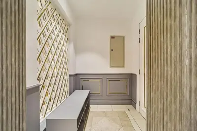 a hallway with a bench next to a wall at FAM Living - 2 Bedroom Old Town Dubai Stay in Dubai