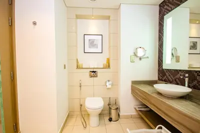 a bathroom with a toilet and a sink at Luxury Fully Furnished 1BHK With Burj Khalifa View at paramount Towers in Dubai