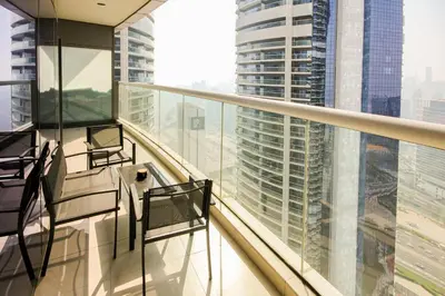 a balcony with chairs and a view of a city at Luxury Fully Furnished 1BHK With Burj Khalifa View at paramount Towers in Dubai