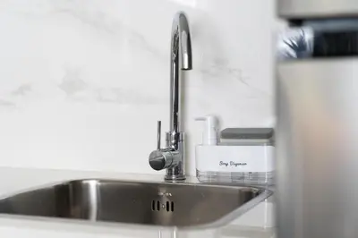 a kitchen sink with a faucet on top of it at Meydan - Modern Family - 2BR Apartment - Azizi Riviera in Dubai