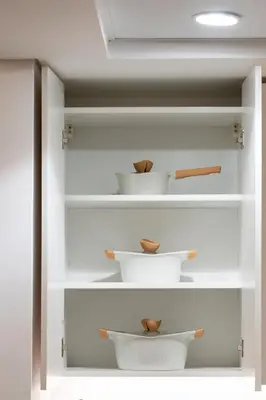 a room with white shelves with bowls on them at Meydan - Modern Family - 2BR Apartment - Azizi Riviera in Dubai