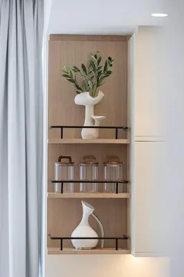 a cupboard with two vases and a plant at Upscale 4BR Villa, Bali Pool, Resort Escape in Dubai