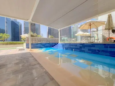 a swimming pool with a view of the city at Waves - Modern City Escape 1BR Apt With Balcony in Dubai