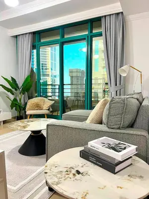 a living room with a couch and a table at Cozy 1BR Stay in Dubai Marina Near Beach and Tram in Dubai