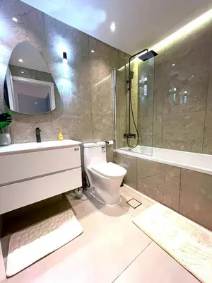 a bathroom with a toilet and a sink and a shower at Cozy 1BR Stay in Dubai Marina Near Beach and Tram in Dubai