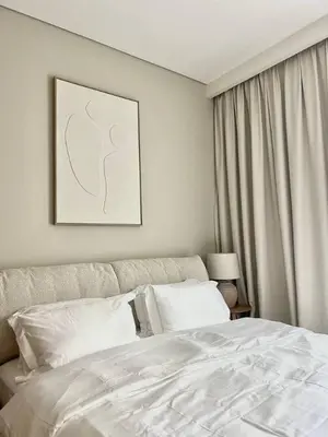 a bedroom with a white bed and a window at Luxury 1BR with Huge Terrace with Creek Beach Lagoon in Dubai