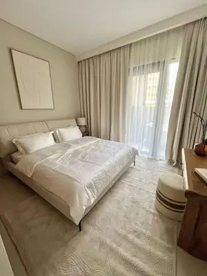 a bedroom with a large bed and a large window at Luxury 1BR with Huge Terrace with Creek Beach Lagoon in Dubai