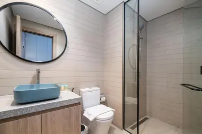 a bathroom with a toilet and a sink and a mirror at Luxury Studio in Peninsula One, Bay Views in Dubai