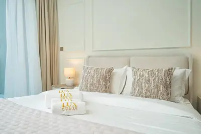 a bedroom with a white bed with two pillows at Luxury Studio in Peninsula One, Bay Views in Dubai