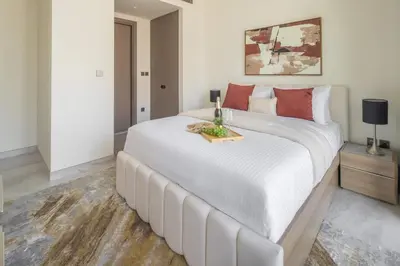 a bedroom with a large white bed with a tray on it at Frank Porter - Peninsula Five, Business Bay in Dubai