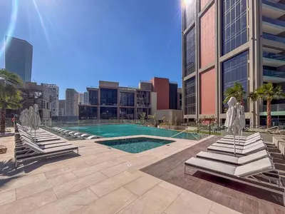 a swimming pool in a city with buildings at Frank Porter - Peninsula Five, Business Bay in Dubai