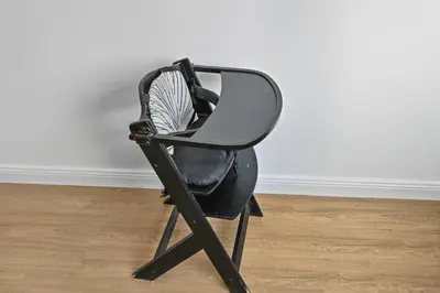 a black chair sitting in a room at Spacious modern 2 Bed and Maids I Sleeps 7 in Dubai
