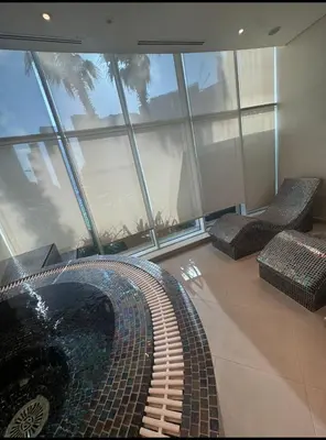 a room with two chairs and a building with windows at Bays edge in Dubai