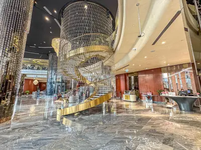 a lobby with a large chandelier in a building at Savis Homes - Stylish 1BR in Business Bay with Burj Khalifa View in Damac Paramount Tower in Dubai