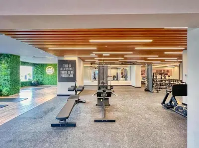 a gym with treadmills and exercise equipment in a building at FIRST CLASS Studio Cozy with City Vibes in Dubai