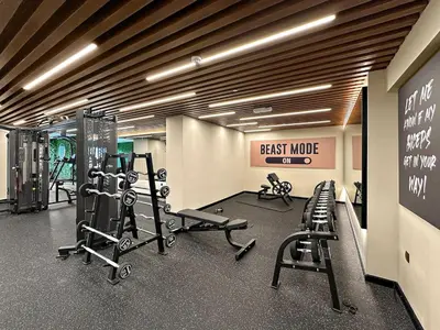 a gym with exercise equipment and a sign on the wall at FIRST CLASS 1BR Stylish , Modern Comfort in Dubai