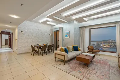 a living room with a couch and a table at Luxe 3BR and Maid Room with Panoramic Dubai Eye View - JBR Beach in Dubai