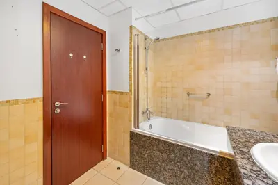 a bathroom with a tub and a sink at Luxe 3BR and Maid Room with Panoramic Dubai Eye View - JBR Beach in Dubai