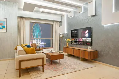 a living room with a couch and a table at Luxe 3BR and Maid Room with Panoramic Dubai Eye View - JBR Beach in Dubai