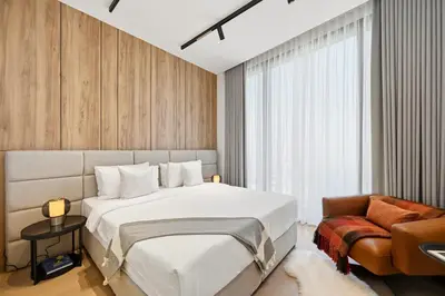 a bedroom with a large white bed and a chair at Prestigious 2BD Seaside Apartment, The Address JBR in Dubai