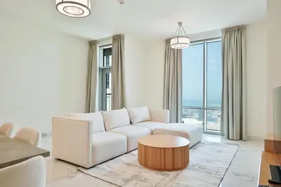 a living room with a white couch and a table at Premium 3-BR Serene Canal View High Floor in Dubai