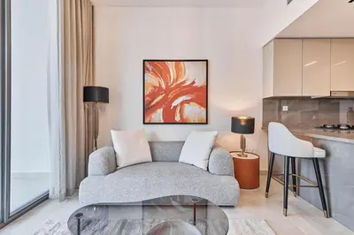 a living room with a couch and a table at Chic 1-Bedroom Retreat in Heart of Business Bay in Dubai