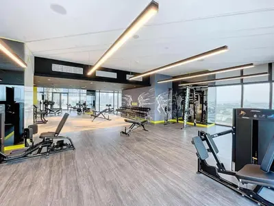 a gym with treadmills and exercise equipment in a building at Luxury 2BR with Skyline Views Prime Business Bay Location in Dubai