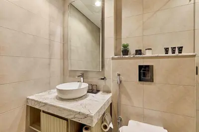a bathroom with a sink and a mirror at Luxury 2BR with Skyline Views Prime Business Bay Location in Dubai