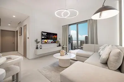 a living room with a couch and a table at NEW LUX High Floor Burj Views in Dubai